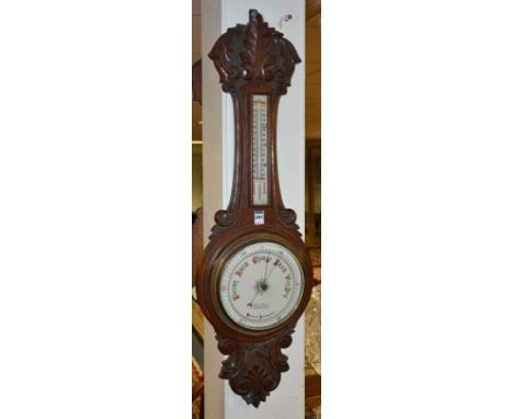 An Edwardian oak 'Banjo' aneroid wall barometer by Dobbie Mcinnes Ltd,with thermometer gauge above white enamel dial, 91cm hi