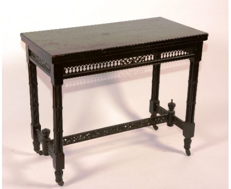 A late Victorian ebonised card table, enclosing felt lined interior, raised on turned supports, 75cm high x 92cm long x 92cm 