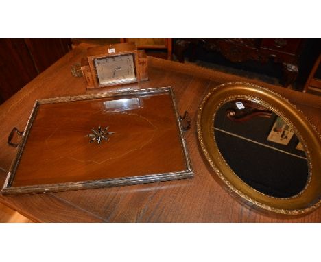 An Art Deco mantle clock, 30cm high, also with a gilt wall mirror and a serving tray (3) CONDITION REPORT: Lot 212 - Not in w