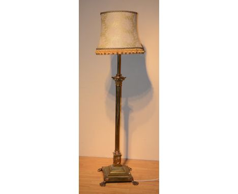 A brass Corinthian column floor lamp, with shade, on square base with lion paw feet, 188cm high