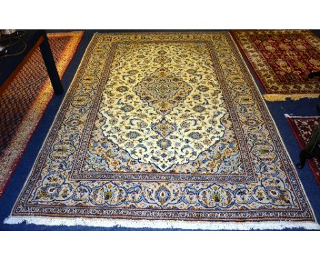 A fine Keshan carpet, in new condition, with central foliate medallion, and foliate motifs on cream ground, 320cm long x 202c