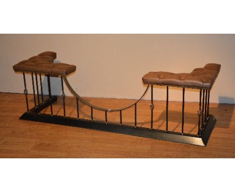 A reproduction club fender, with tan leather button back and stuffover top, raised on ebonised metal frame, 51cm high x 173cm