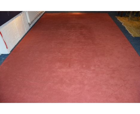 A full roll of pink domestic carpet, 673cm x 290cm