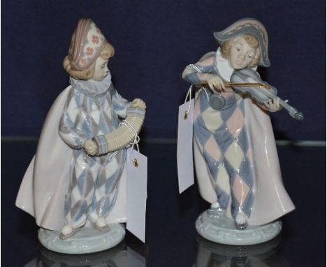 A pair of Lladro child musician jester figures, in harlequin costume, one playing the fiddle, the other playing the squeeze b