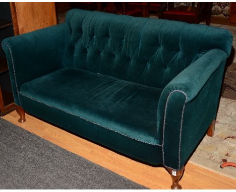 A vintage upholstered button back two seater settee, upholstered in turquoise velour, raised on cabriole supports, 76cm high 