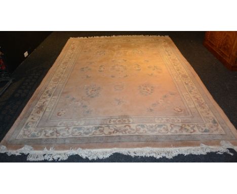 A large Chinese carpet, with typical floral and butterfly design over pale ground of creams, greens and greys, 364cm x 273cm