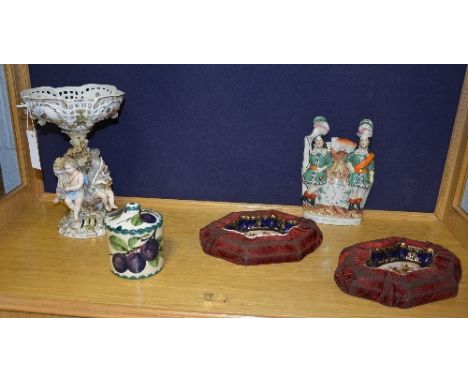 A German porcelain centre piece in the Meissen style, decorated with putti style figures to the base, blue crossed sword mark