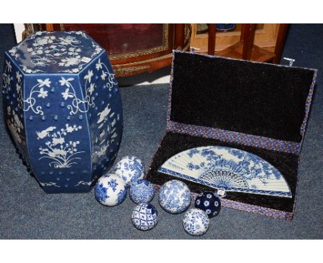 A modern oriental blue and white ceramic garden seat, decorated with white birds and foliage on bue ground, together with a m