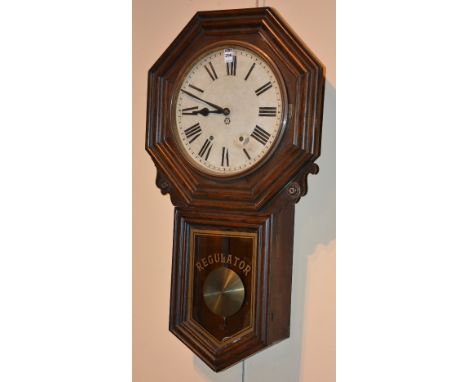 A Victorian American regulator wall clock by New Haven Clock Co, the octagonal top enclosing white enamel dial, with pendulum