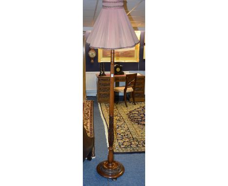 A mahogany floor lamp with shade, raised on circular base, 178cm high