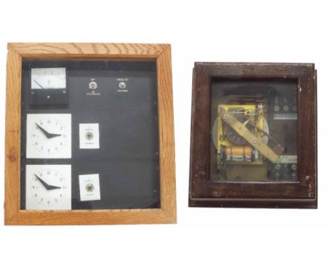 Distribution unit with rotary slaves, within a light oak case, 14" high; also another electrical timer within an oak glazed r