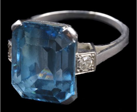 * Ring. An art deco style white metal ring, set with a large step cut aquamarine with canted corners, approximately 12 mm x 1