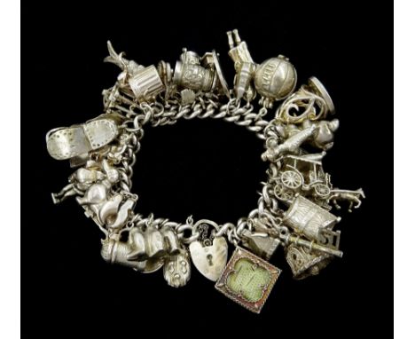 Silver charm bracelet, charms including dachshund, trophy football, spiders web, cheque book, bunny, poodle, 21 key, shoe hou