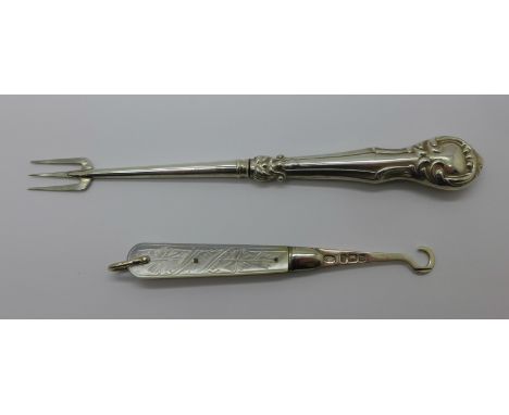 A silver button hook and a silver pickle fork