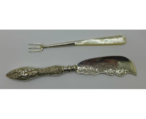 A silver butter spade and a silver pickle fork