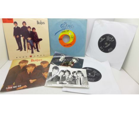 Eight The Beatles singles, a Beatles postcard and a Rolling Stones postcard