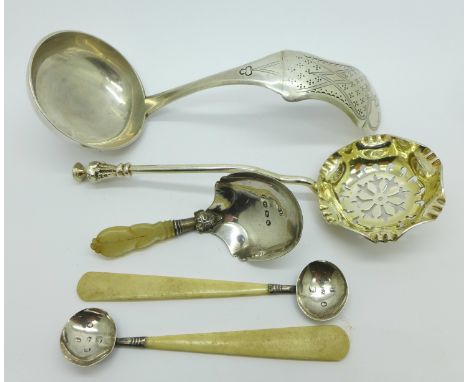 A silver ladle, sifting spoon, a Victorian silver caddy spoon by George Unite and a pair of silver salt spoons