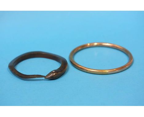 A carved horn snake bracelet and a yellow metal bangle