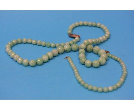 A Jade graduated necklace with gold and diamond clasp, and a matching bracelet