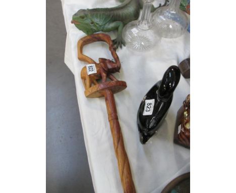 A carved wooden stick with elephant deisgn