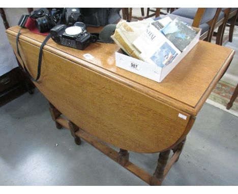 A large light oak gate leg table