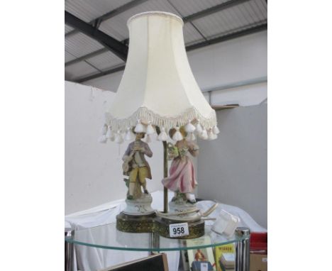 A figural table lamp with shade