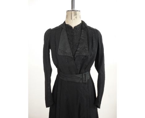 An 1880s lady's jet beaded black moire cloak, with round lace trimmed collar, and set-in bat wing sleeves, front fastening wi