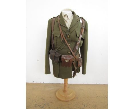 A uniform and accoutrement display comprising King's Liverpool Regiment officer's Service Dress tunic, Sam Browne belt, sword