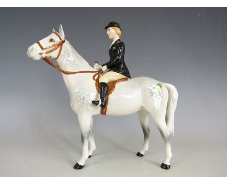 A Beswick pottery figurine of a huntswoman on a grey dappled horse, model number 1730, 21 cm