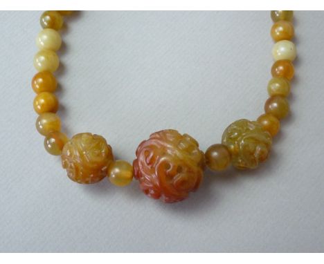 A Chinese yellow jade bead necklace