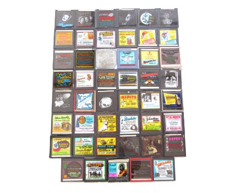 47 various 1930s-1940s magic lantern slides depicting advertisements for Cumberland businesses and some national brands