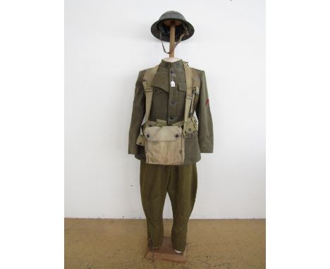 A mannequin display of First World War American Army 'doughboy' uniform and equipment including tunic, breeches, side cap, st