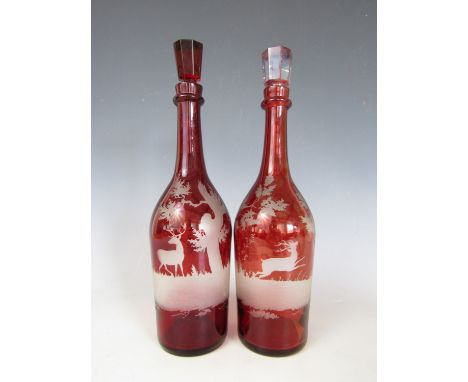 A pair of Victorian ruby flashed and wheel cut decanters, decorated in depiction of stags and a hound amid woodland, 33 cm 