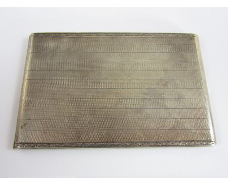 A George V silver cigarette case, of oblong form and bearing engine-turned banded decoration, Cohen & Charles, Chester, 1929,