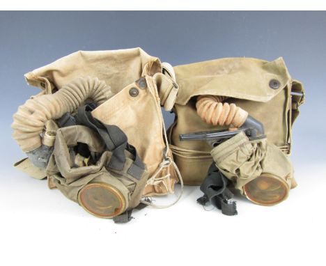 Two First World War American gas masks and haversacks