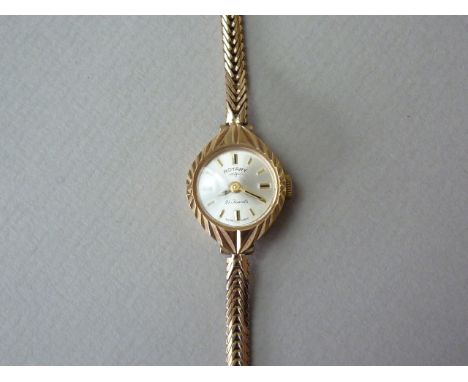 A 1960s lady's 9ct gold cased Rotary wristlet watch, with circular silvered face and baton markers, in a faceted navette shap