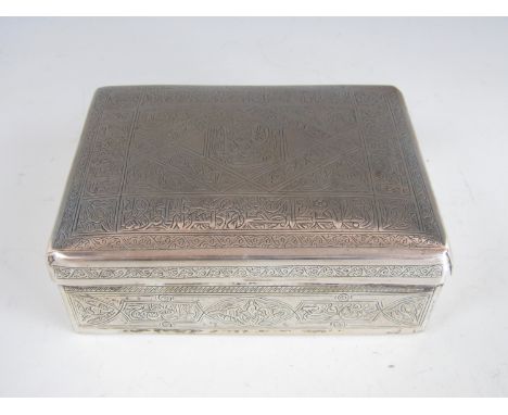 An Egyptian white metal cigarette box, the engraved decoration incorporating calligraphy, Cairo assay marks, mid 20th Century