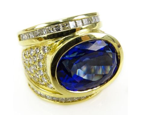 Approx. 13.50 Carat Oval Cut Tanzanite, 2.60 Carat Diamond and 18 Karat Yellow Gold Ring. Tanzanite with vivid saturation of 