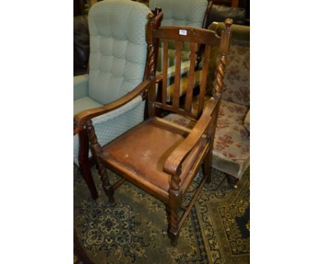 A 1940's Oak Carver Chair having shaped and plain slat back, shaped top rail, rear barley twist supports with ball finial top