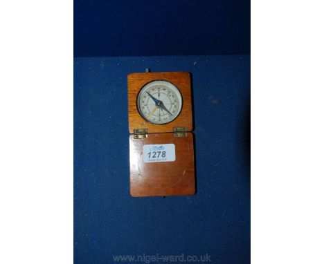 A Travelling Compass in an oak case.