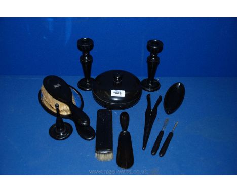 An ebony Dressing Table Set comprising candlesticks, lidded pot, ring stand, mirror, etc. (12 pieces in all)