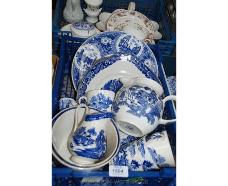 A quantity of blue and white 'Willow' pattern china including bowls, jugs, plates and Spode egg cups.