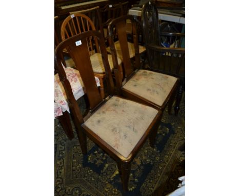A pair of 1920's Mahogany Dining Chairs, shaped back supports with wide splat back, faded tapestry style drop-in seats, on sa