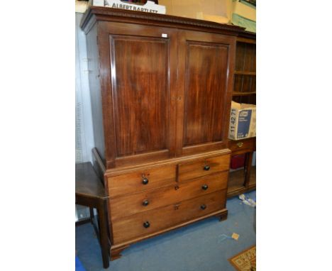 A mid 19th c. Mahogany Linen Press with moulded cornice over a pair of opposing single raised and fielded moulded panel doors