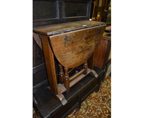 An unusual late 19th c. Oak drop-leaf Table in rustic style construction, oval top on plank end supports on sleigh feet with 