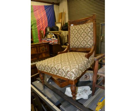 A Victorian Walnut show frame Parlour easy Chair having carved top rail on moulded supports, reeded frieze, on ring turned fr