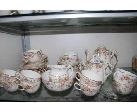 A pretty TL & K part Teaset, white ground with floral decoration and comprising cups and saucers, tea plates, bread and butte