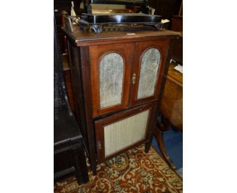 An elegant 19th c. Walnut Music Cabinet having pierced and fret cut galleried back in turned supports, the moulded top over p