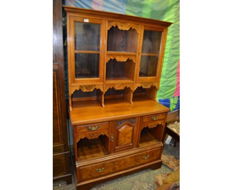 An Edwardian Walnut Dresser having moulded cornice to the top, with two opposing single pane glazed doors separated by, two s