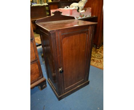 A Victorian Walnut Pot Cupboard, shaped upstand back, single panel door with moulded detail, black ceramic knob, opening to r